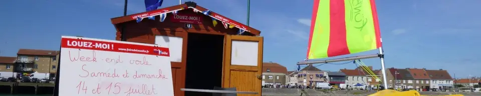 Le bureau de la base nautique sur la digue, à côté des voiles des embarcations.